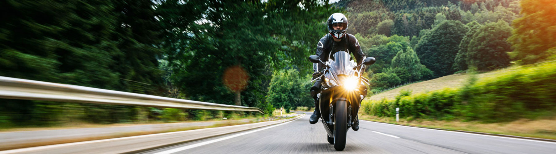 Standard sport motorcycle speeding down scenic road