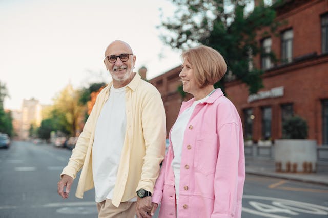 Happy Senior couple walking around town at dusk