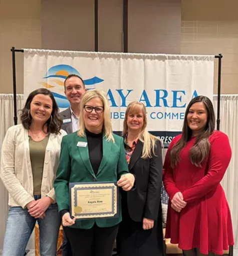 Angela holding award in front of Bay Area Chamber of Commerce with Wildfire employees