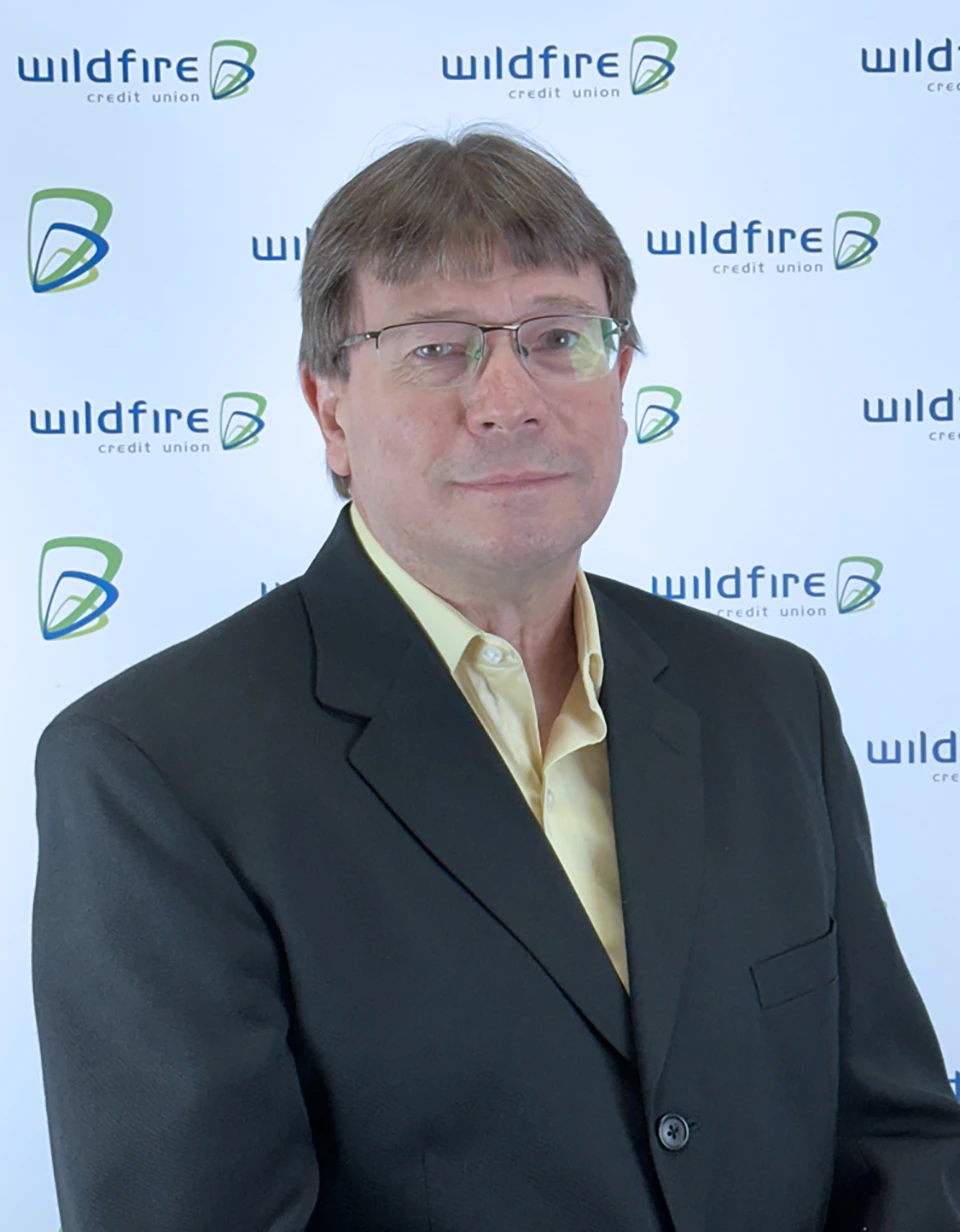 Darrell Burchfield CTIO Darrell Burchfield with Wildfire Credit Union logo on white background behind him.