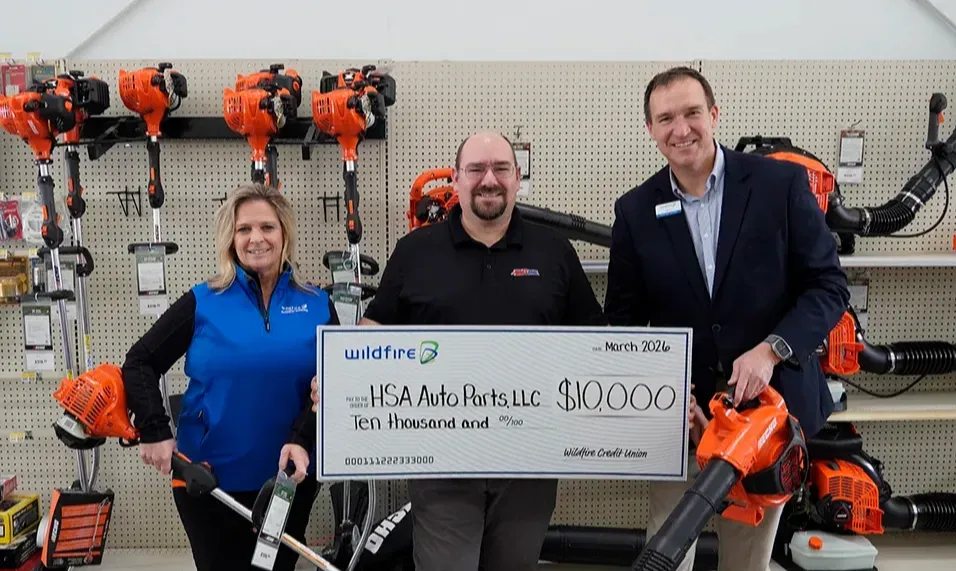 Wildfire presenting grant check for $10,000 to HSA Auto Parts owner.