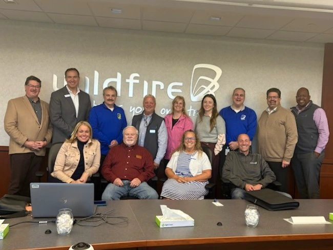 Board members and chiefs smile for picture for Paul Sudoff's retirement.