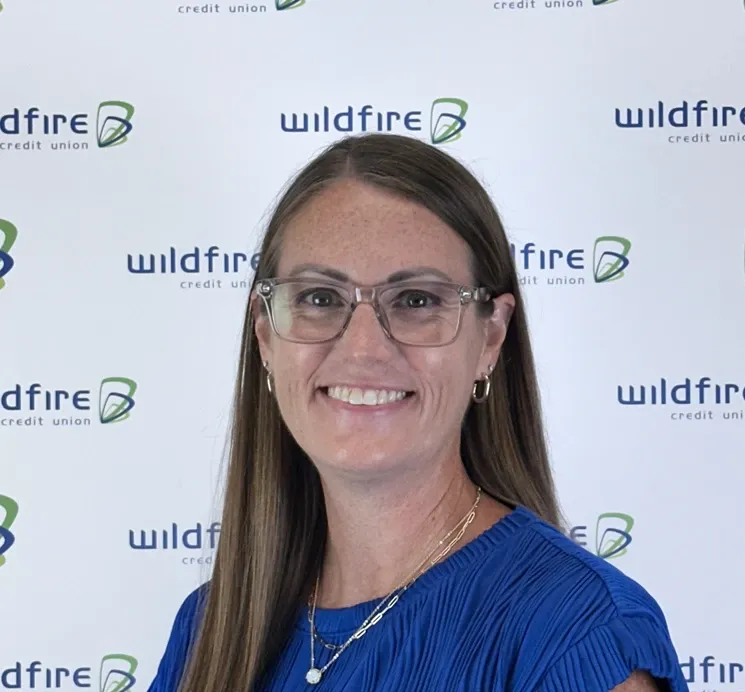 Rachael Klinski with Wildfire Credit Union logo on white background behind him.