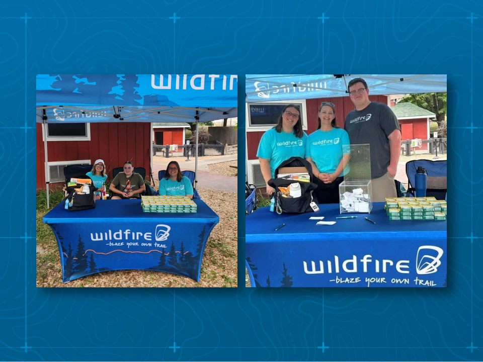 Wildfire Employees standing in front of tent and table at Saginaw Zoo.