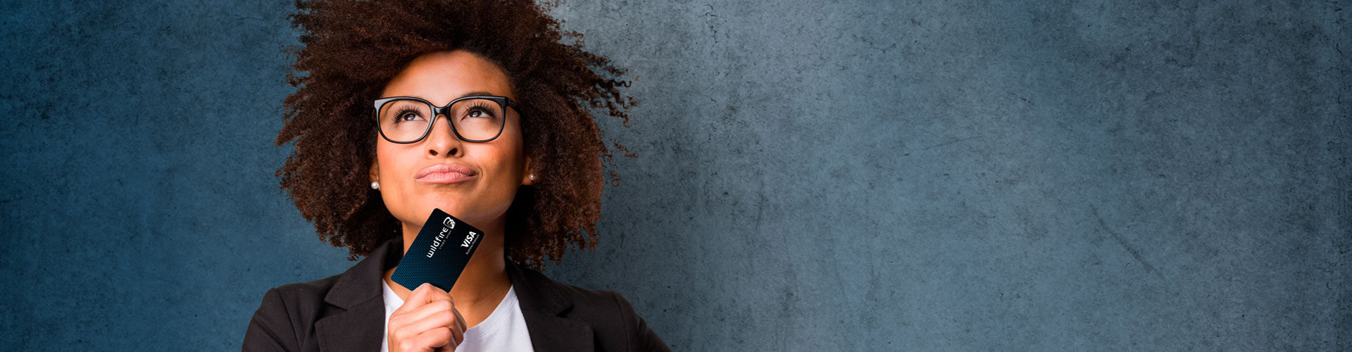 Woman with a credit card looking on confidently Woman with a credit card looking on confidently