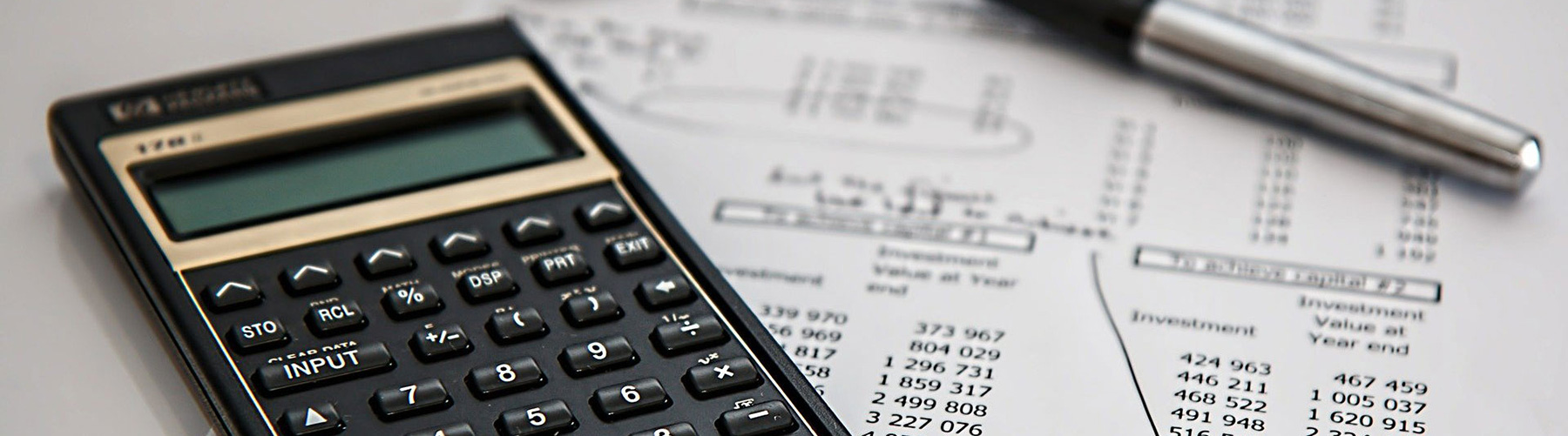 Calculator on a financial document with a pen
