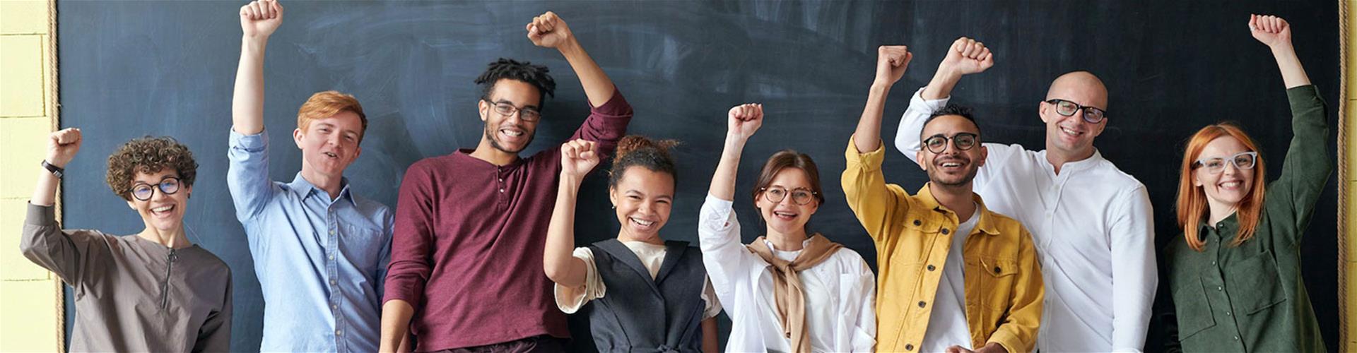 Joyful Work team celebrating with hands held high Joyful Work team celebrating with hands held high