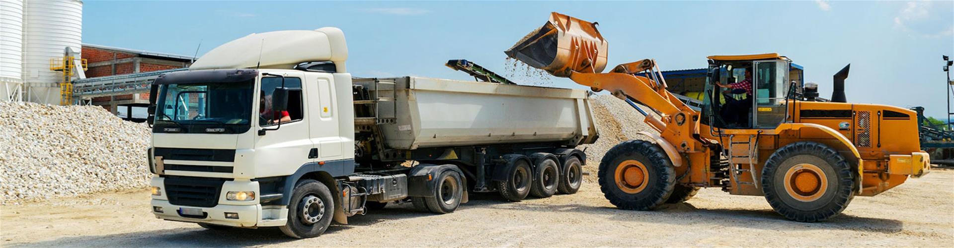 loader vehicle loading material into white cargo truck loader vehicle loading material into white cargo truck