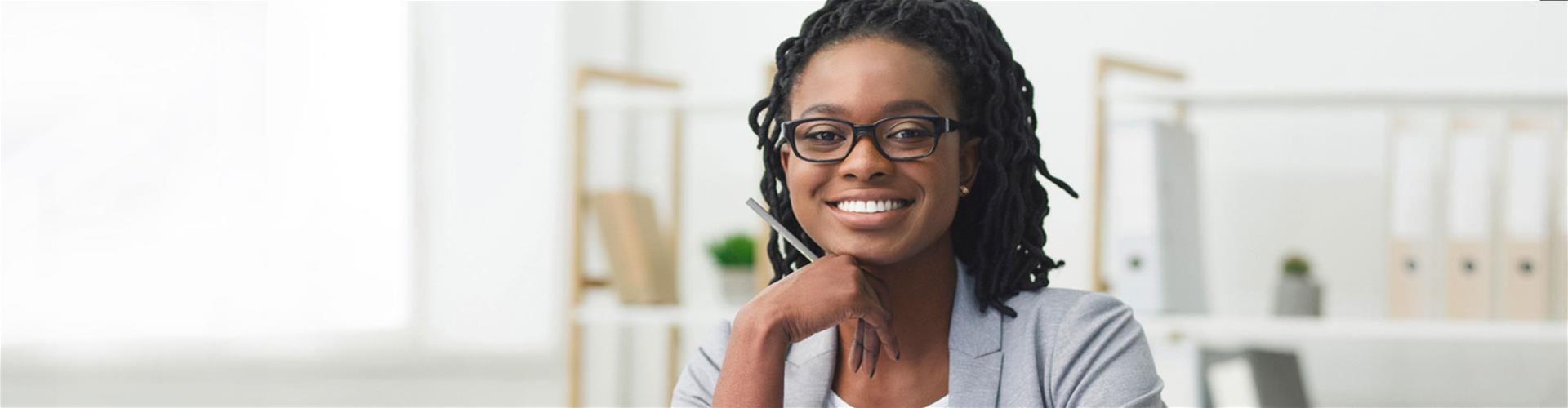 Smiling business woman sitting at a desk