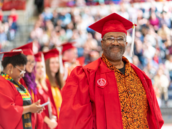 Gentleman in a red graduation cap and gown