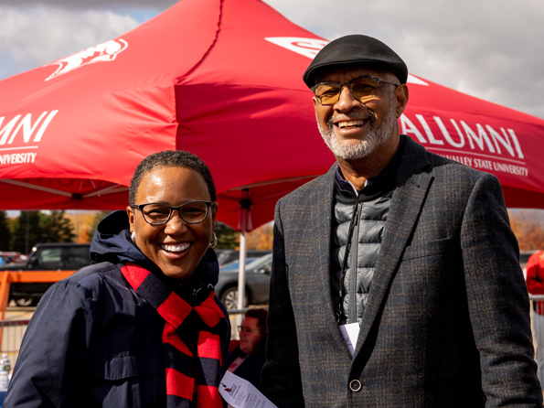 Couple standing in front of SVSU Canopy tent