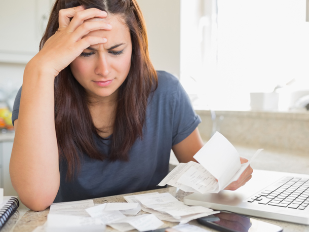 Cardinal Perks Credit Counseling Frustrated woman looking at receipts