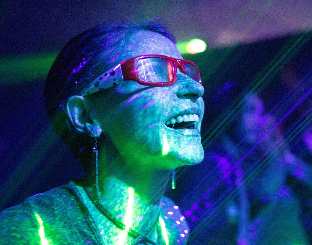 Girl smiling at concert with light show