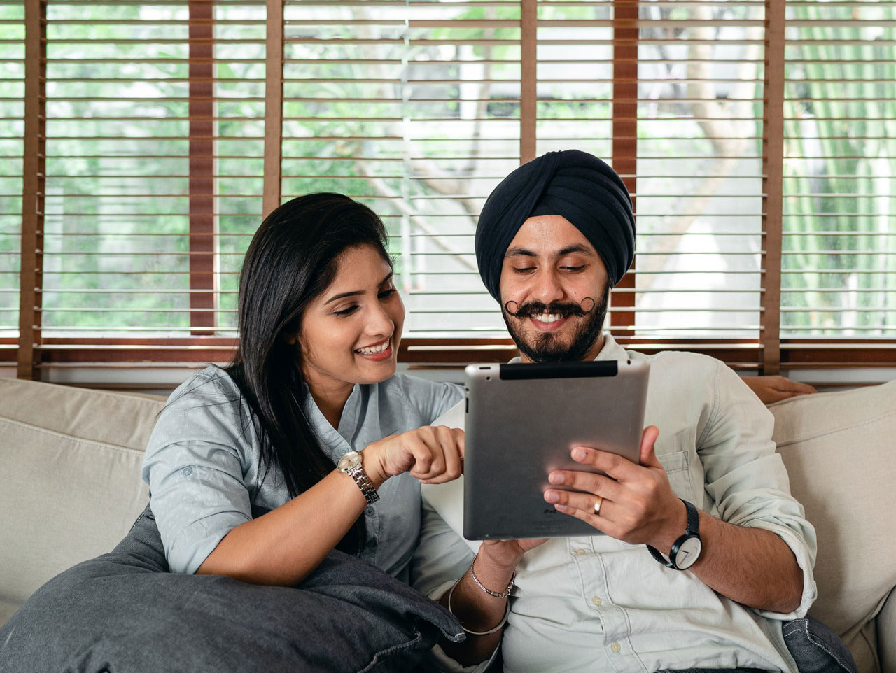 Couple happily using a tablet Couple happily using a tablet