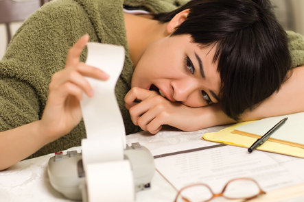 Woman stressed while paying bills Woman stressed while paying bills