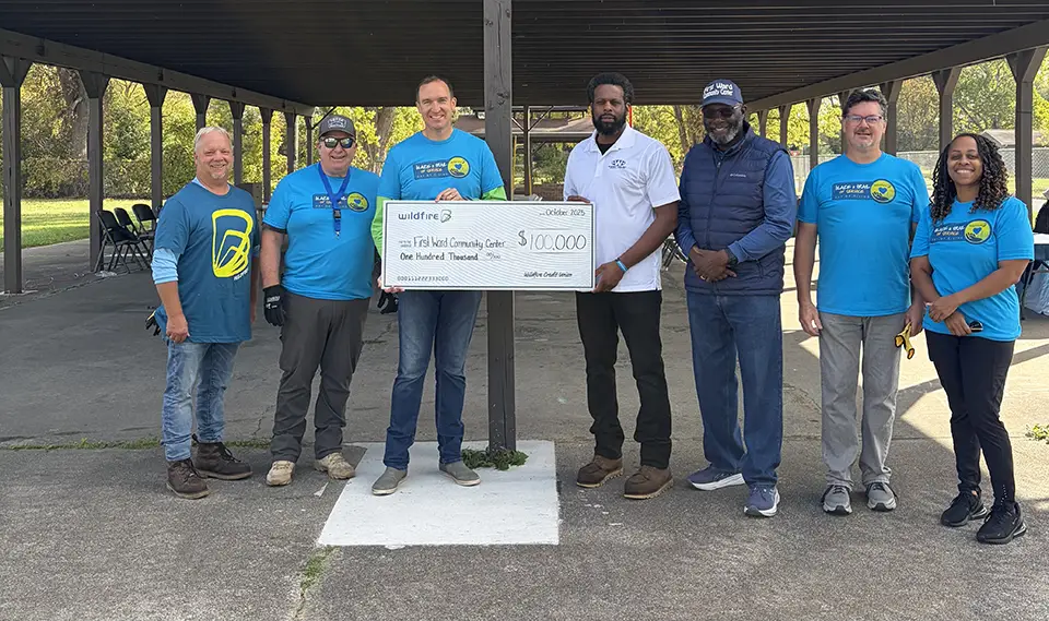 Wildfire CEO and board members present First Ward with a check for $100,000.