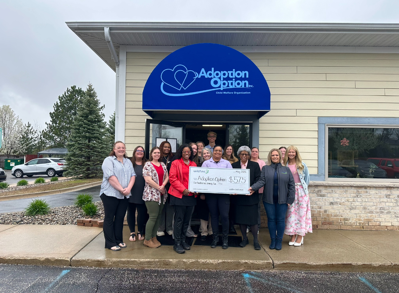 Adoption Option Check presentation in front of their building