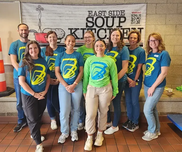 Wildfire team volunteers on 9/23/25 and smiles for photo at Saginaw's East Side Soup Kitchen
