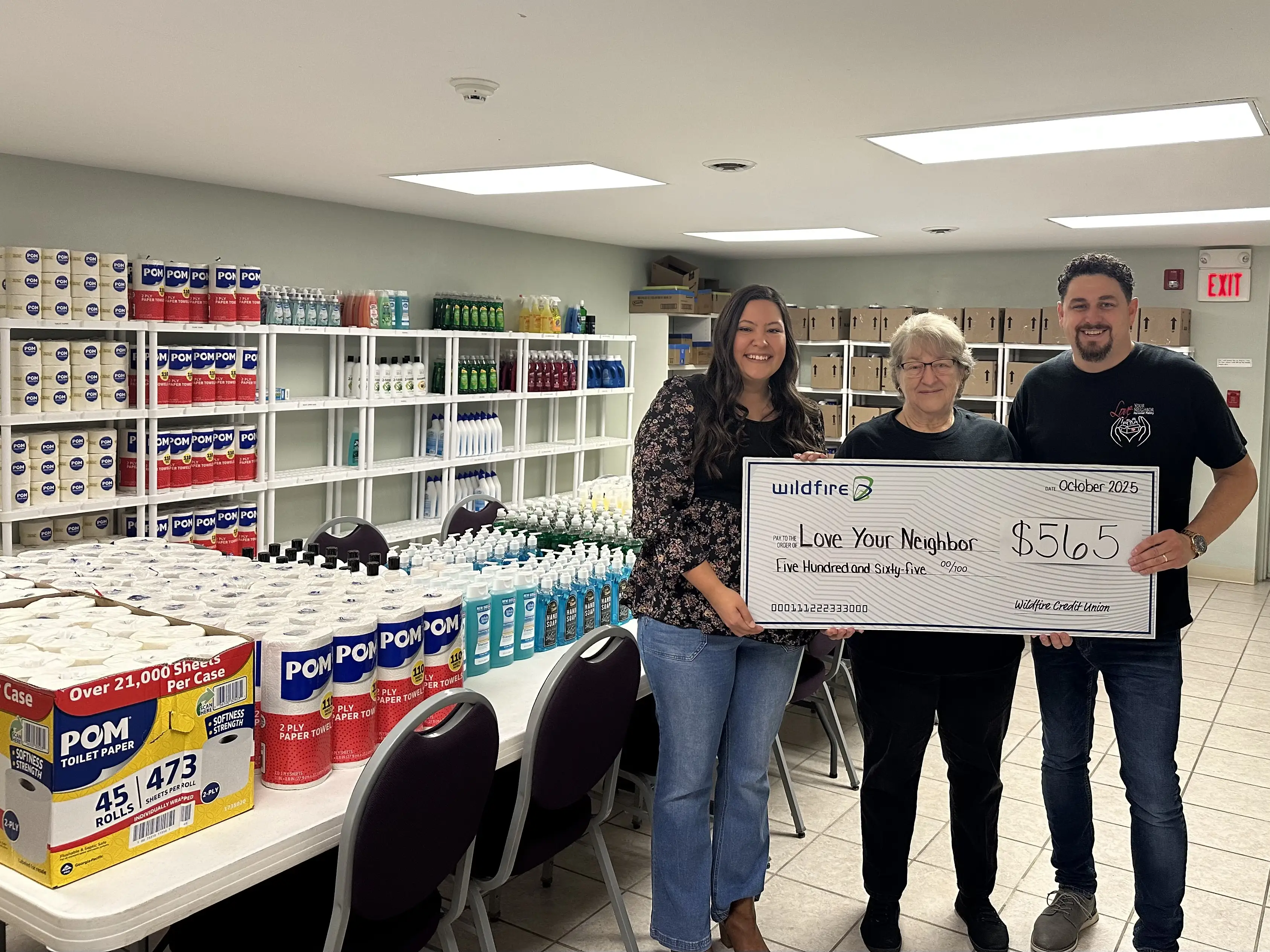Wildfire presents a check for $565 to Love Your Neighbor.