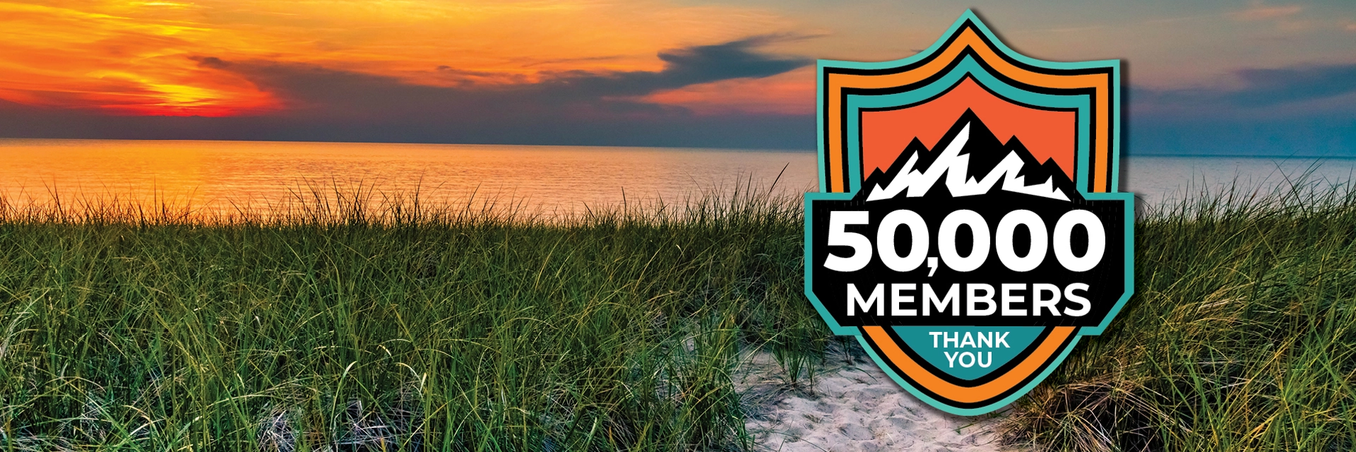 Sunset on a Michigan beach with a mountain badge of 50,000 members and thank you.