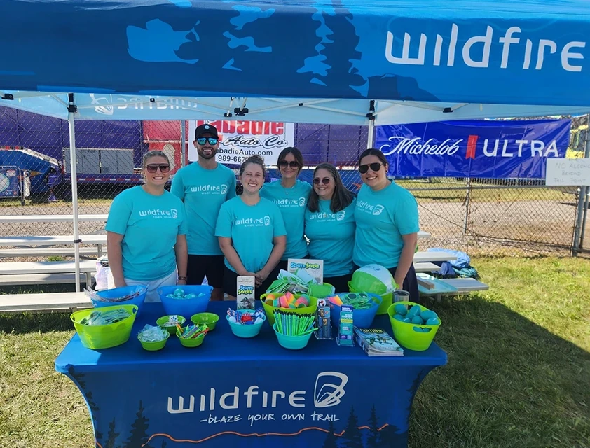 Wildfire employees hand out trinkets and prizes to kids and parents at St. Stan’s Polish Festival in Bay City.