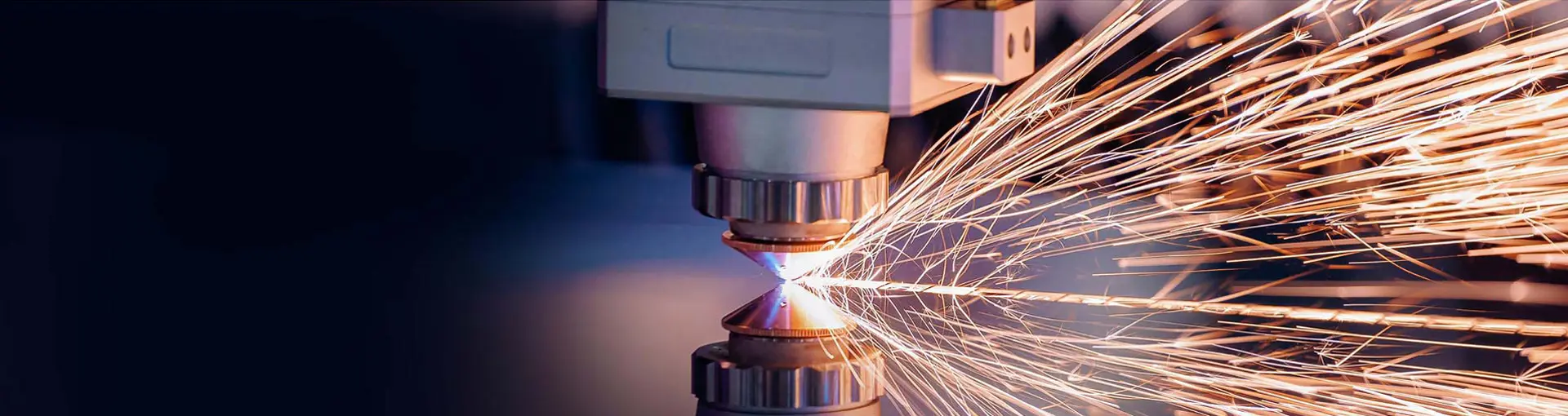 Close-up of a laser cutting machine emitting sparks during metal fabrication.