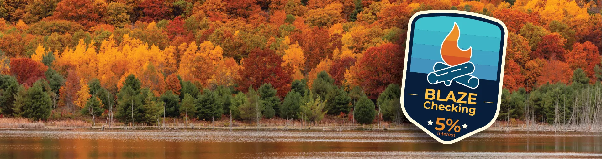 Blaze Checking badge with an array of fall trees on the edge of a Michigan lake.