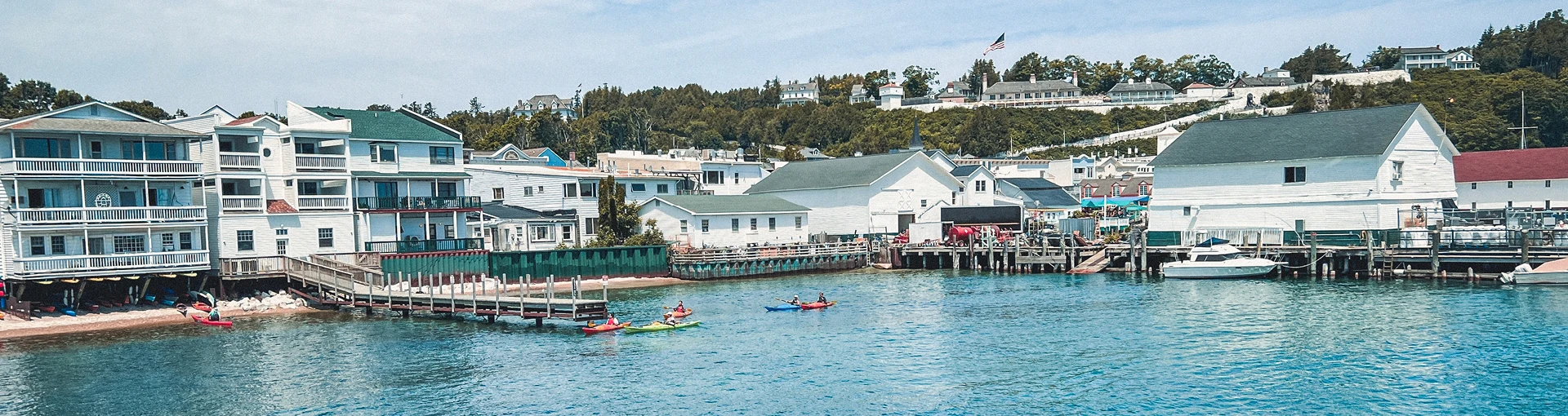 View of the inland harbor at Mackinac Island with people kayaking in the water.