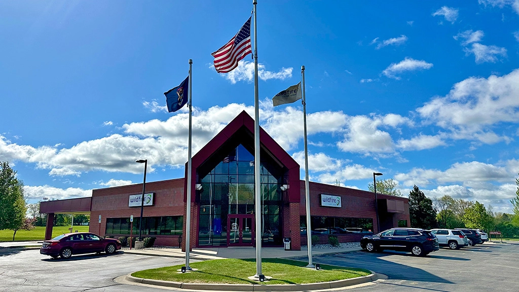 Midland branch on a blue sky summer day with clouds and flags blowing in the wind.