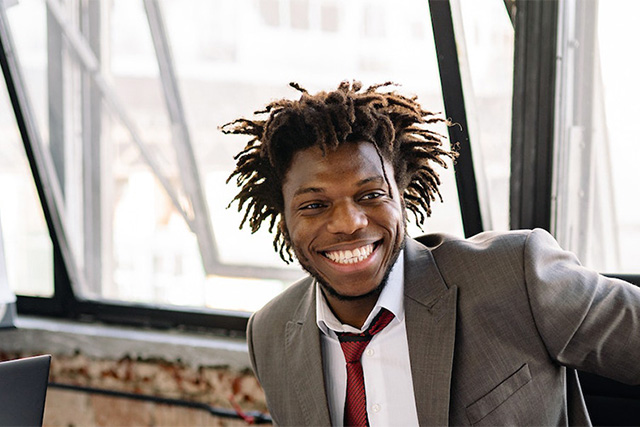 Young man in suit sitting at his computer