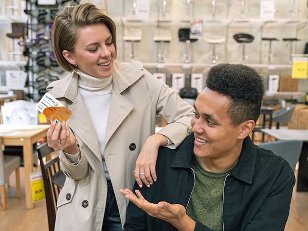 Two happy employees talking about Wildfire Debit Card