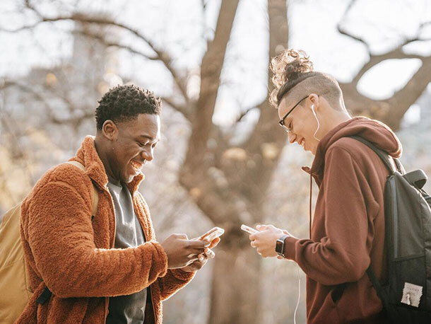 Friends texting on smartphones outside Friends texting on smartphones outside