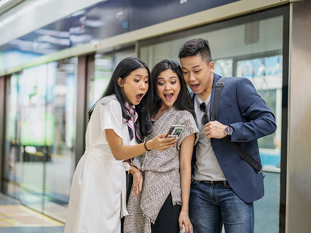 Amazed friends looking at smartphone Amazed friends looking at smartphone