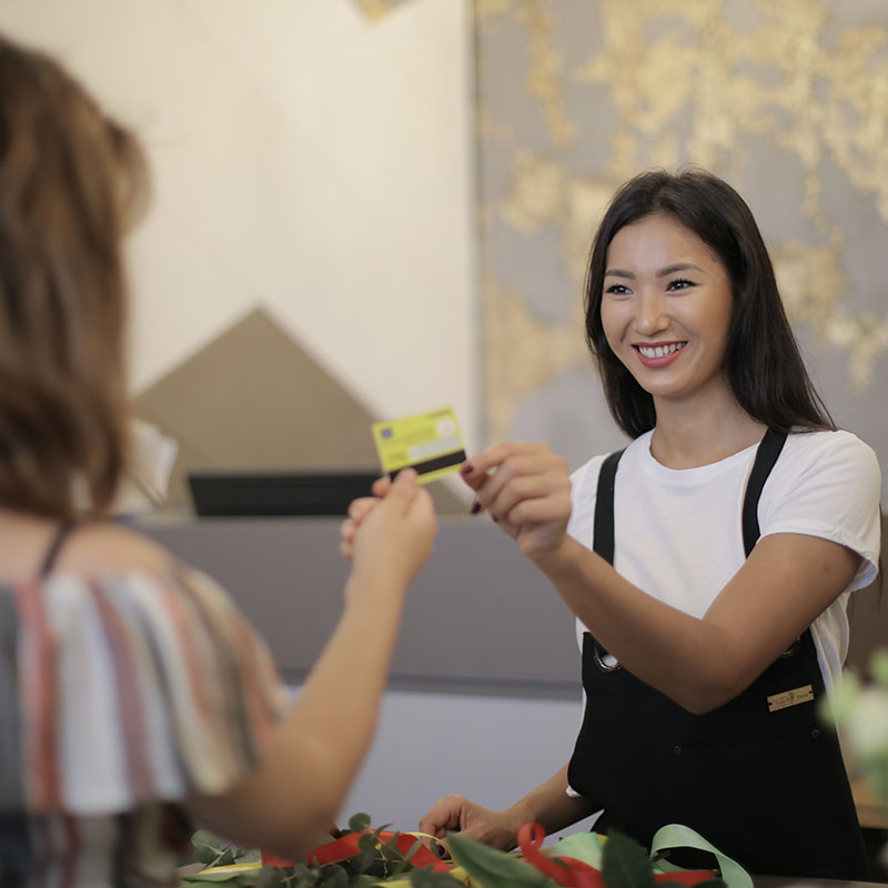 Happy female paying with a credit card