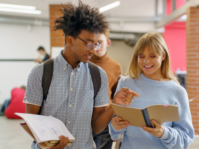 Young Man and Woman Having A Conversation At School Young Man and Woman Having A Conversation At School