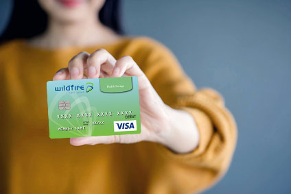 Woman holding Wildfire HSA Debit Card