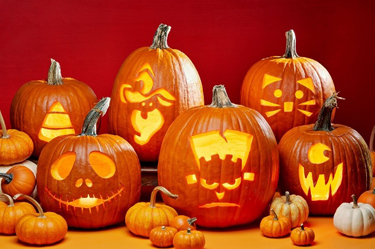 a group of carved pumpkins with candles in them