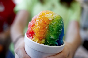 Shred and Snowball event Person holding a rainbow snow cone
