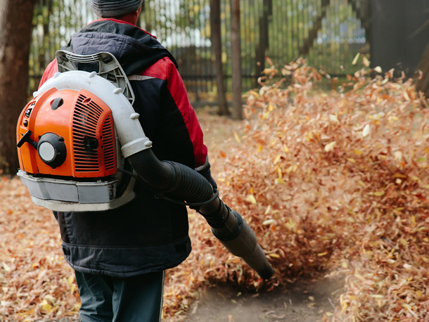 Man blowing leaves for yardwork Man blowing leaves for yardwork