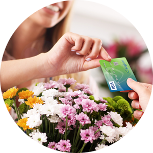 Female happily paying for flowers with Wildfire Rewards Visa Credit Card