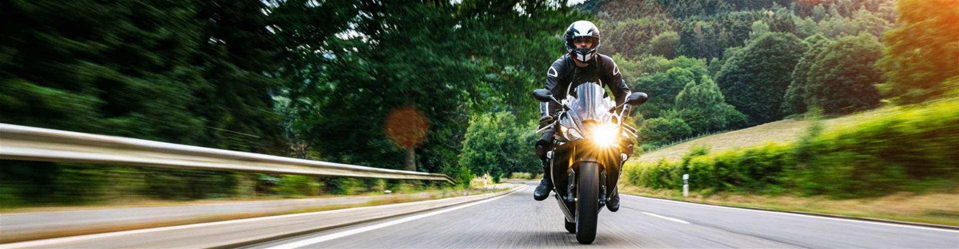 Standard sport motorcycle speeding down scenic road Standard sport motorcycle speeding down scenic road