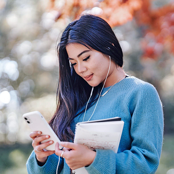 Young cheerful woman using smartphone Young cheerful woman using smartphone