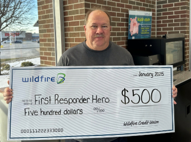 Christoper Secor Christopher Secor smiling and Holding a check for 500 dollars