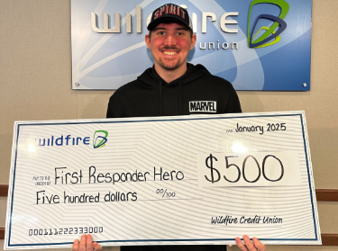 Eric Kocks Eric Kocks smiling and holding a check for 500 dollars